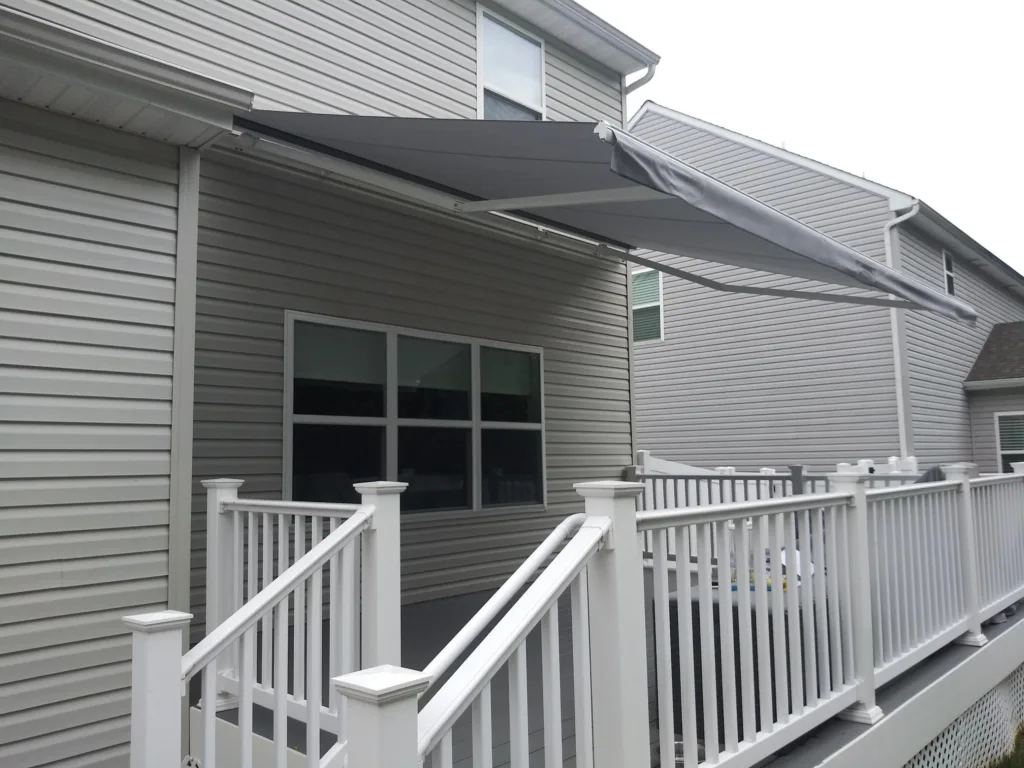 kccs gray awning on back deck of home with white railings