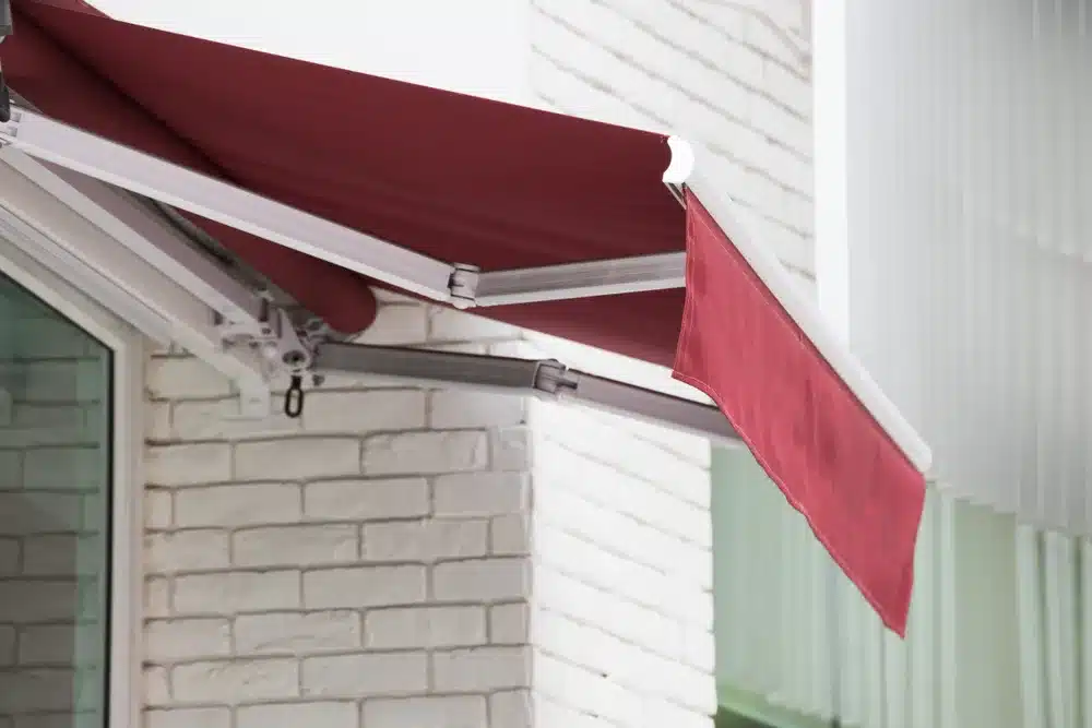 retractable awning red fabric and white hardware