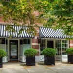 Charming Storefront Featuring Striped Awnings and Green Shrubs, Newton, Massachusetts, USA