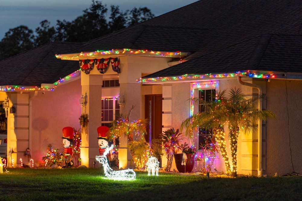 Festive yard display with glowing lights and Christmas decorations at a Florida family home. New Year holiday joy.